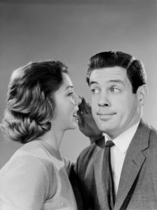 h-armstrong-roberts-woman-whispering-into-man-s-ear-man-pulling-funny-face